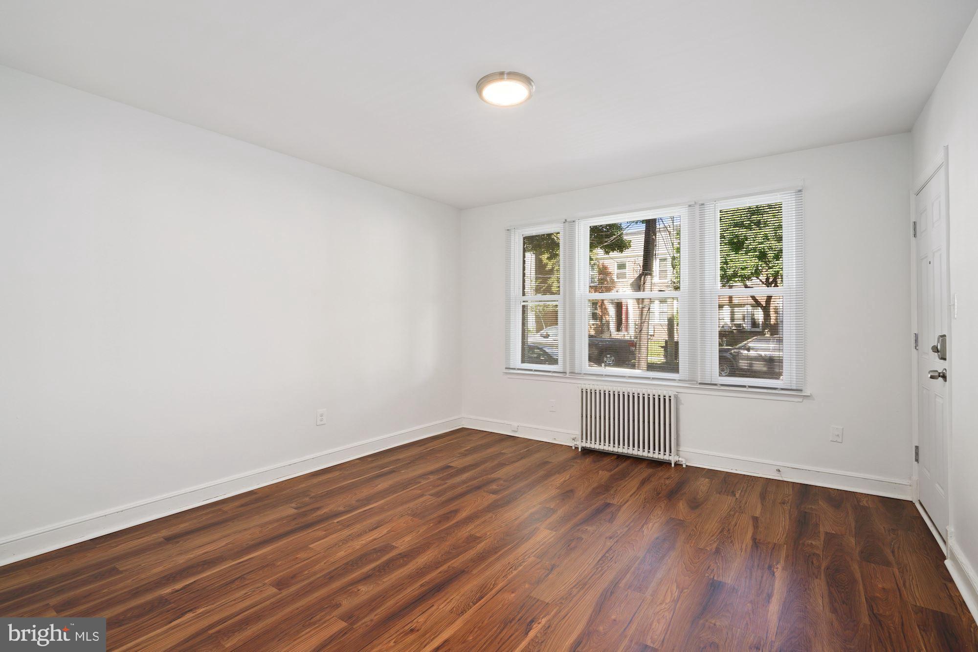 1612 17th Place Southeast Washington, DC 20020 - Photo 16 of 35 an empty room with wooden floor and windows