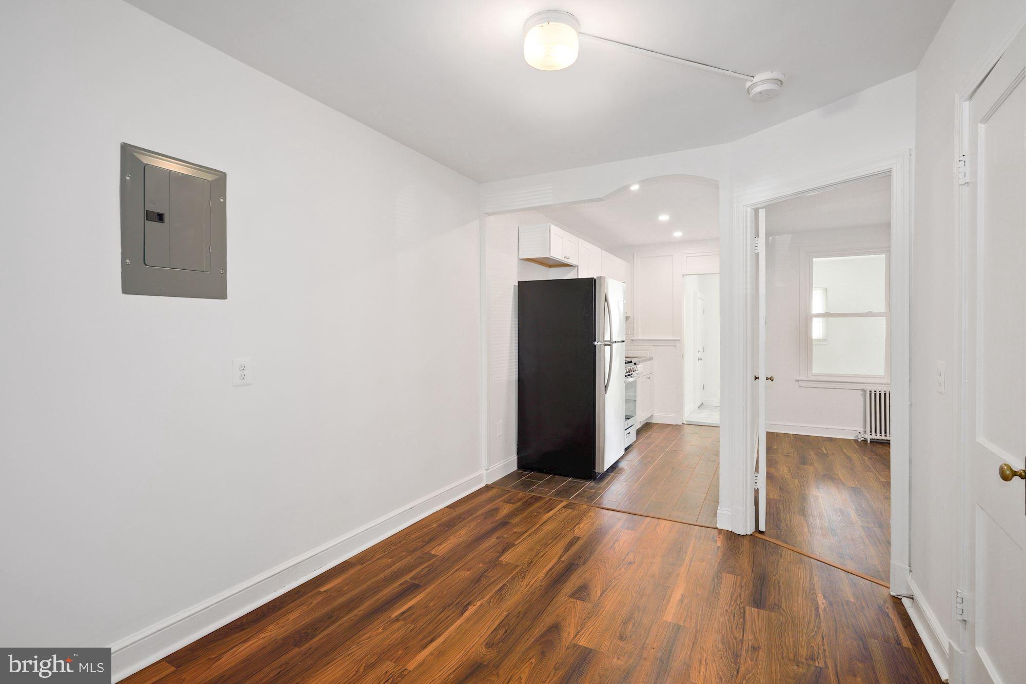 1612 17th Place Southeast Washington, DC 20020 - Photo 18 of 35 wooden floor in an empty room with a window