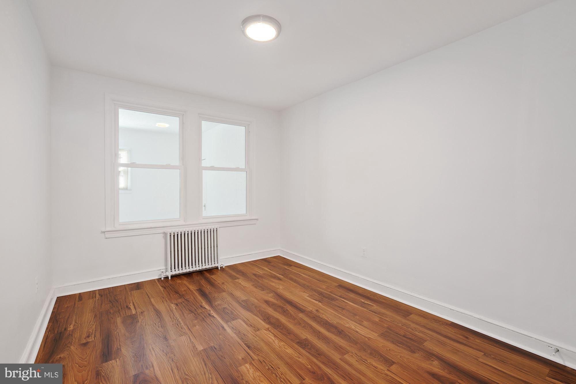 1612 17th Place Southeast Washington, DC 20020 - Photo 19 of 35 an empty room with wooden floor and windows