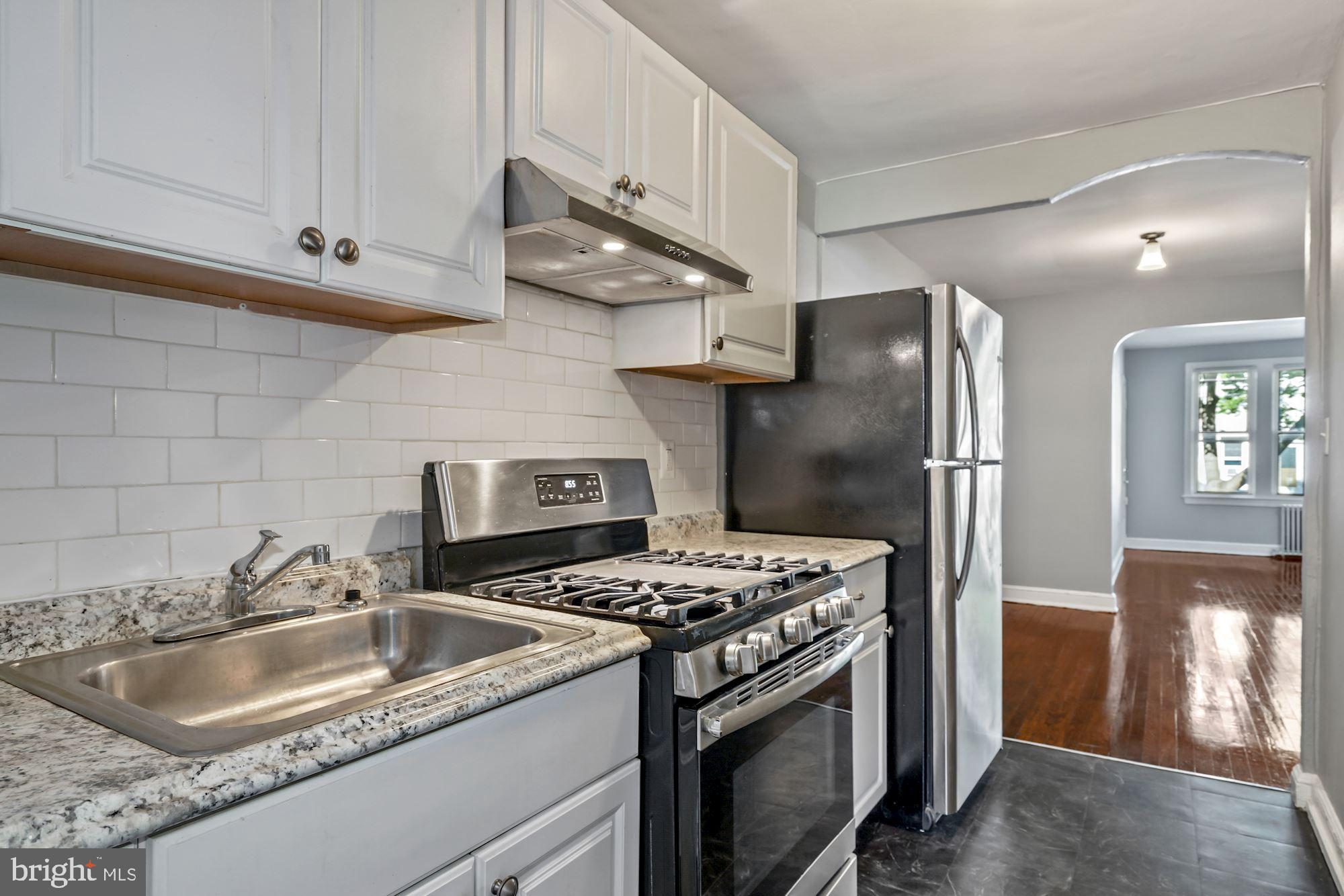 1612 17th Place Southeast Washington, DC 20020 - Photo 23 of 35 a kitchen with stainless steel appliances granite countertop a sink stove and refrigerator