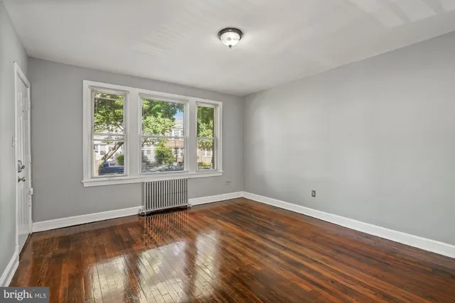 a view of a room with wooden floor