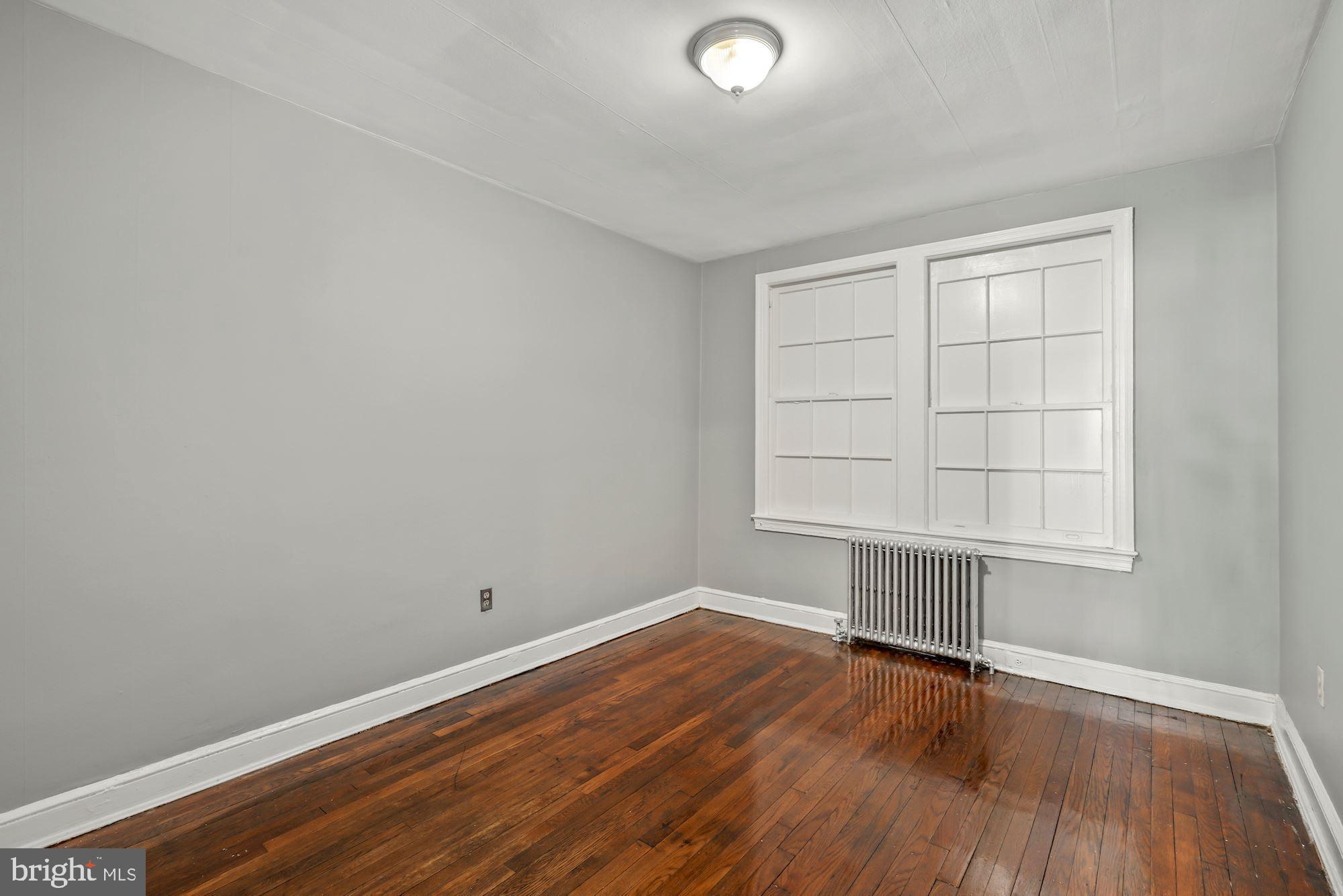 1612 17th Place Southeast Washington, DC 20020 - Photo 28 of 35 an empty room with wooden floor and windows