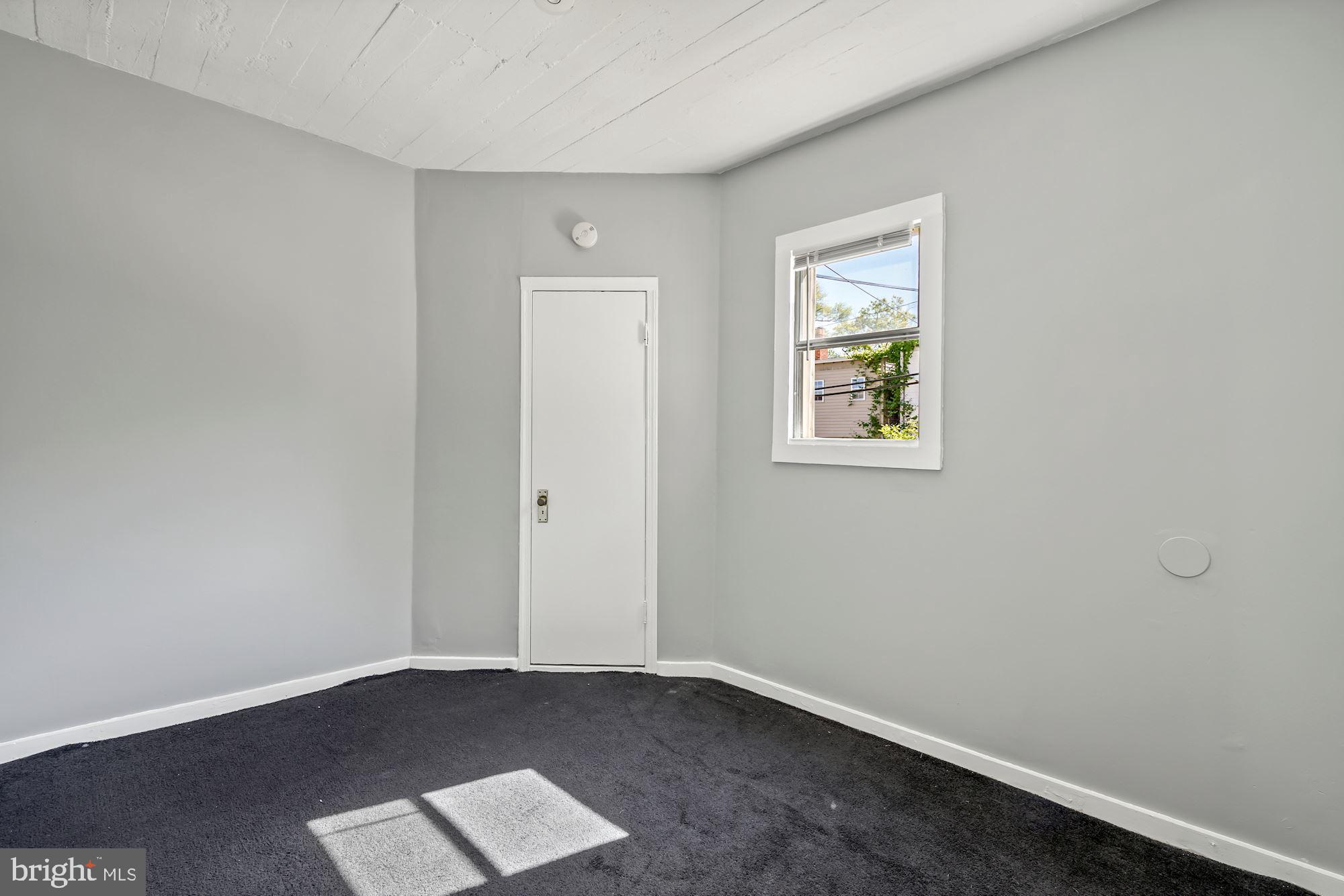 1612 17th Place Southeast Washington, DC 20020 - Photo 30 of 35 an empty room with wooden floor and windows