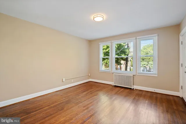 a view of a room with wooden floor