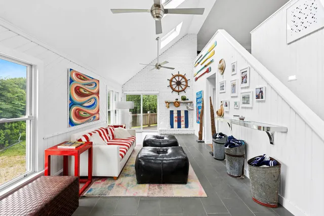 a bedroom with furniture and a large window