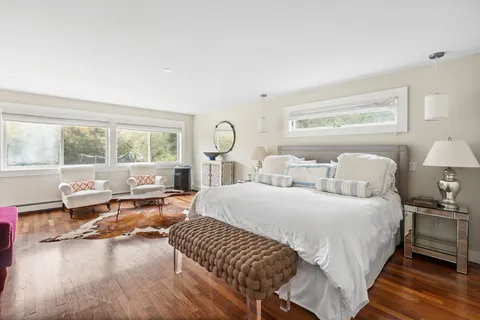 a bedroom with a bed and a large window