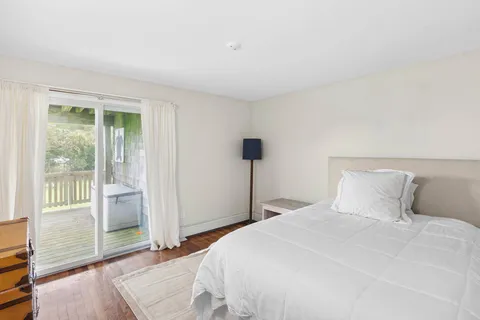 a bedroom with a bed and a large window