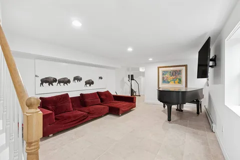 a living room with furniture and a glass door