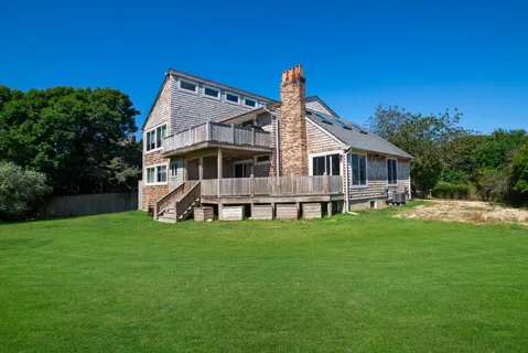 a view of a house with a backyard