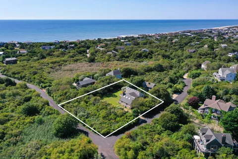 an aerial view of a house with a big yard