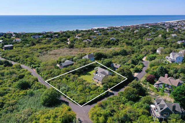 an aerial view of a house with a big yard