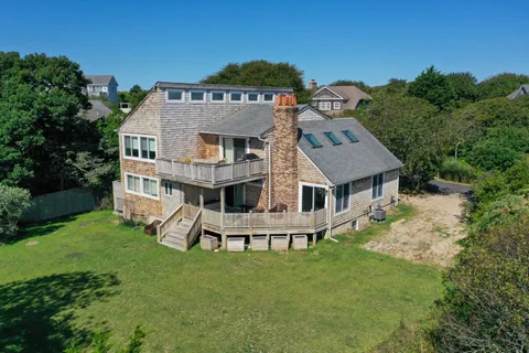 an aerial view of a house with a garden and trees