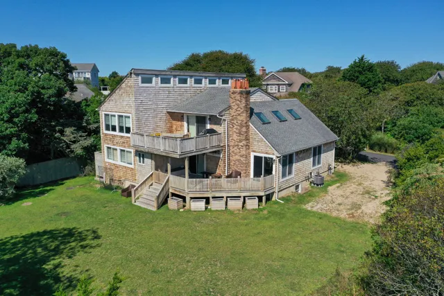 an aerial view of a house with a garden and trees