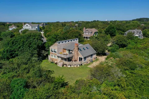 an aerial view of a house with a yard