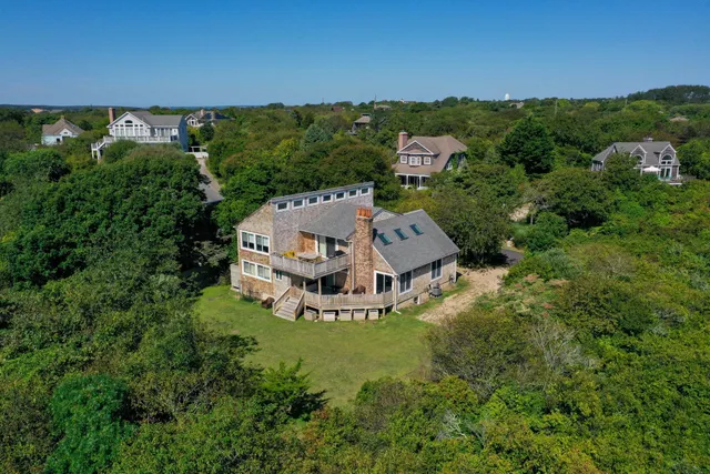 an aerial view of a house with a yard