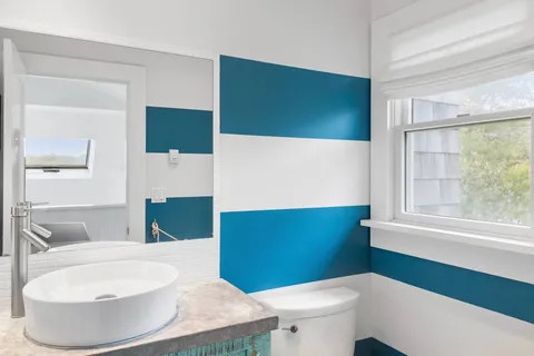 a bathroom with a toilet a sink and a mirror