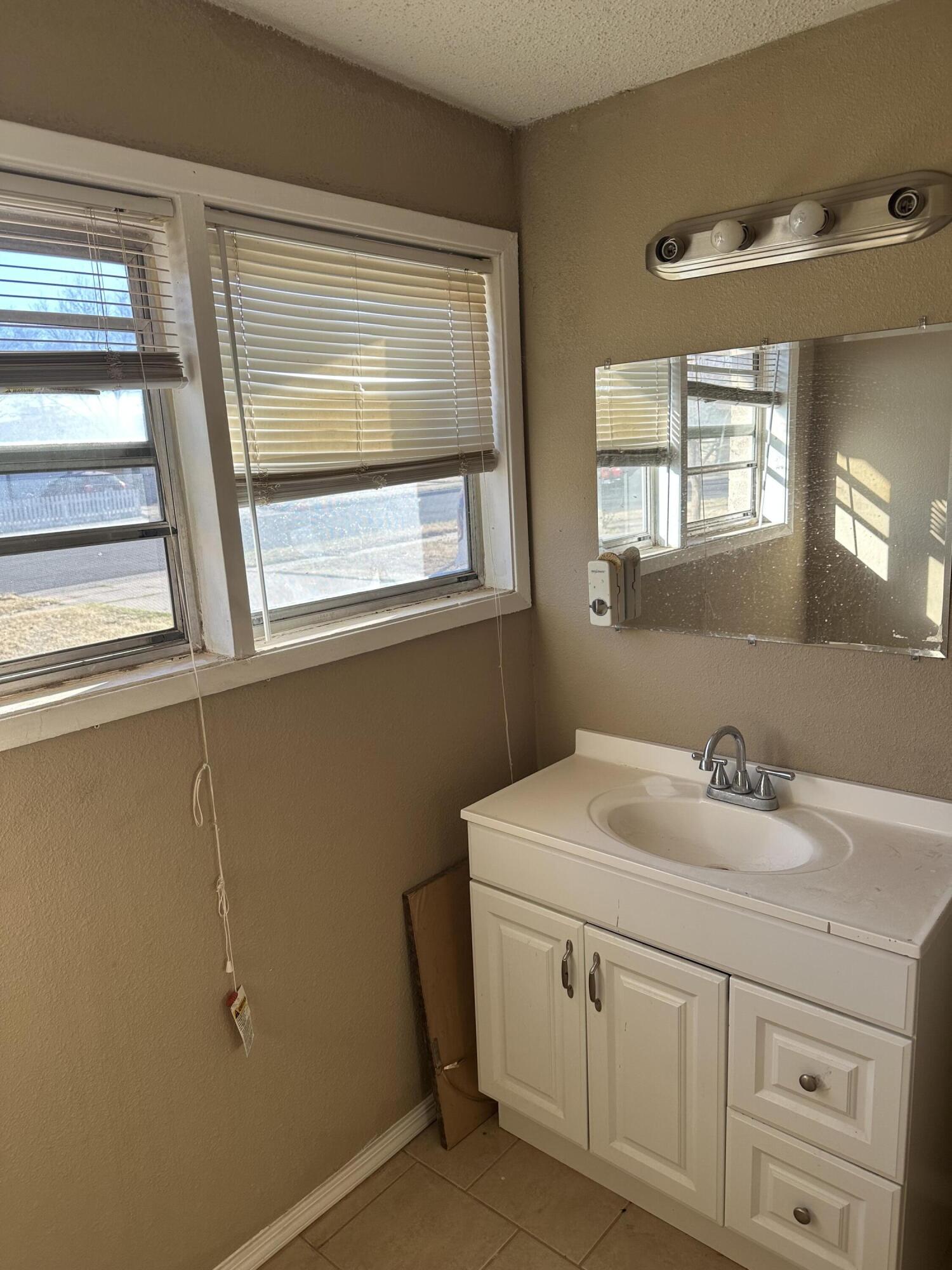 2416 47th Street Lubbock, TX 79412 - Photo 15 of 23 a bathroom with a sink and a vanity