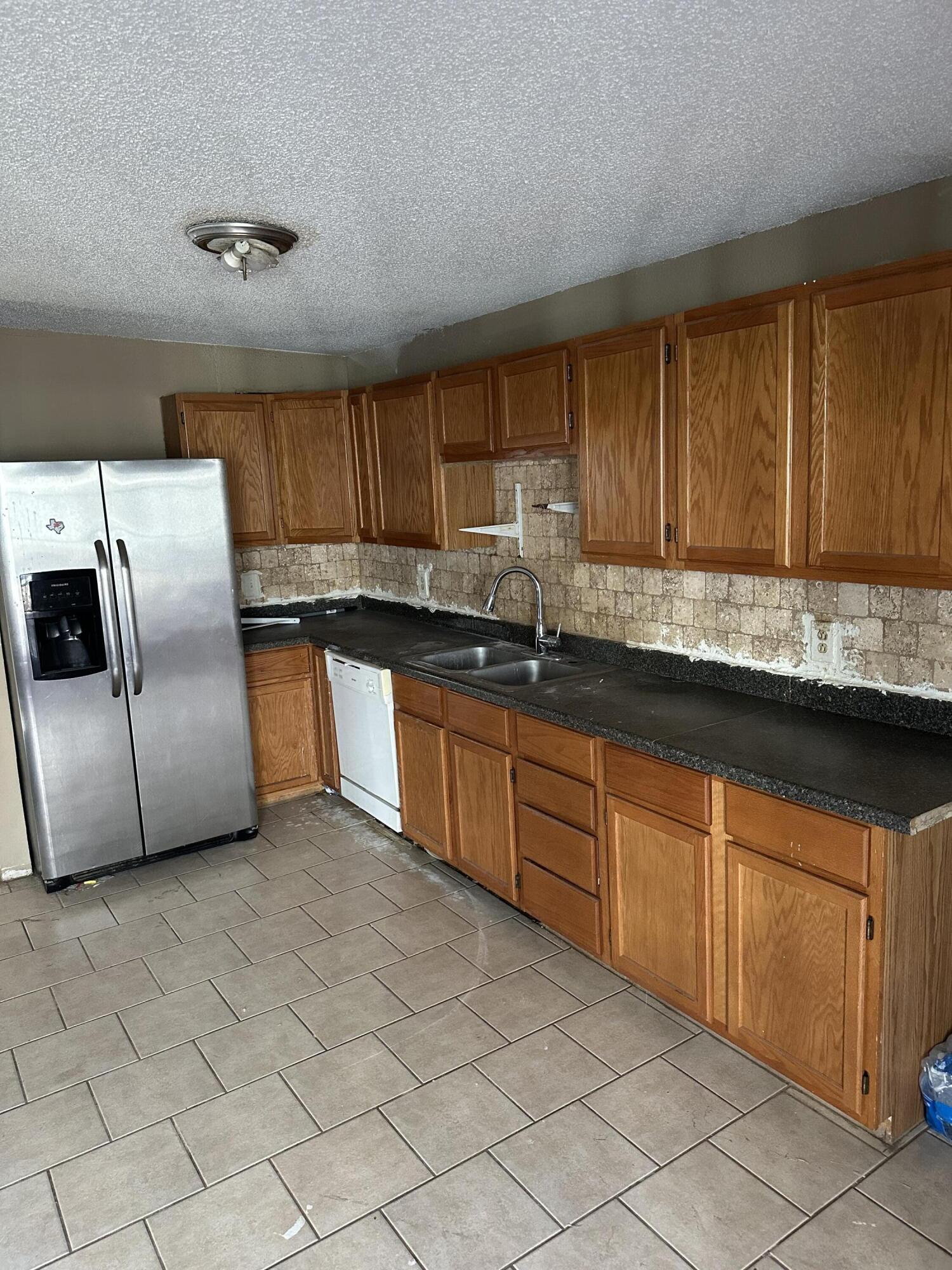 2416 47th Street Lubbock, TX 79412 - Photo 3 of 23 a kitchen with stainless steel appliances granite countertop a sink and a stove