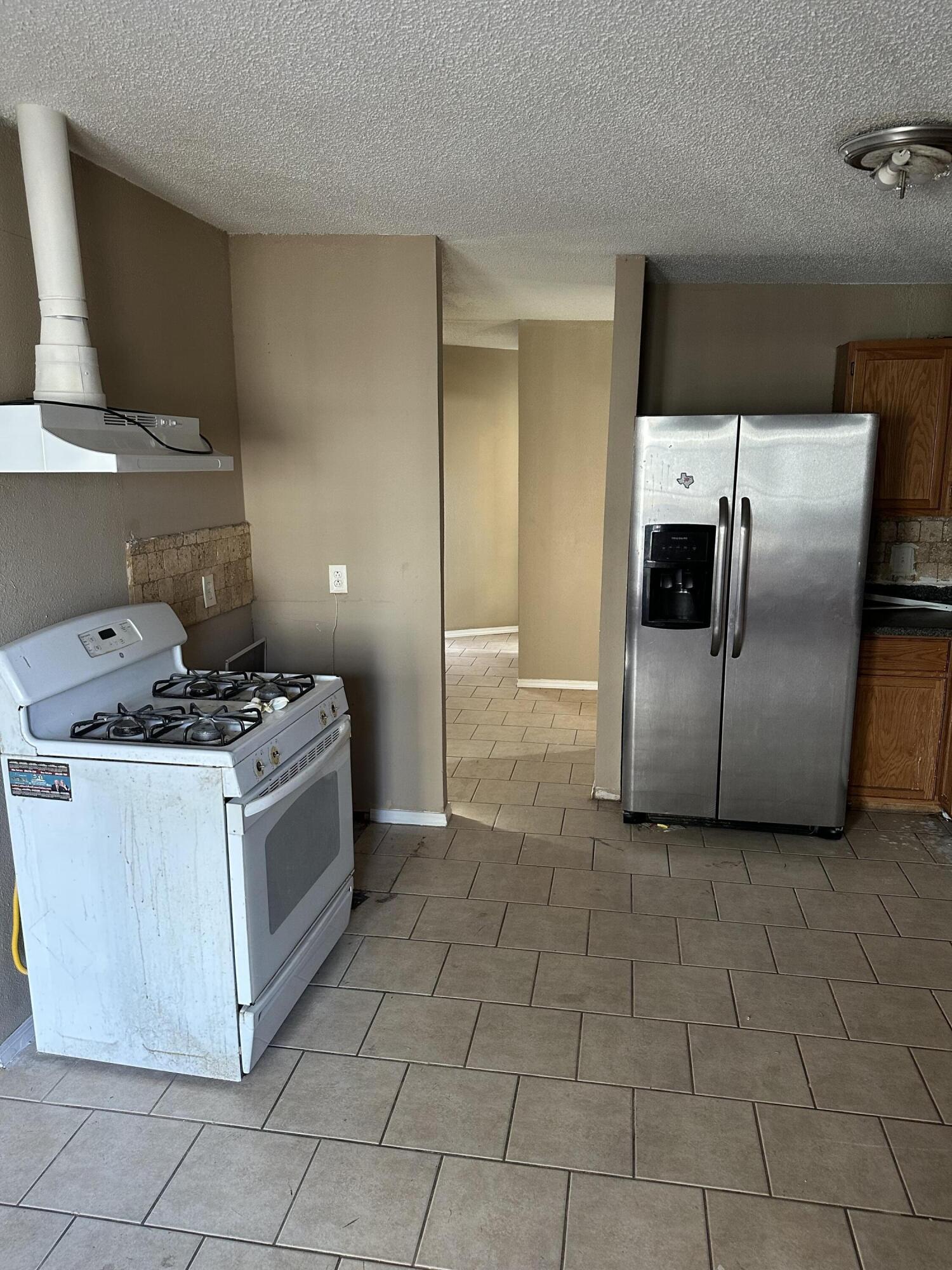 2416 47th Street Lubbock, TX 79412 - Photo 5 of 23 a kitchen with cabinets and steel stainless steel appliances