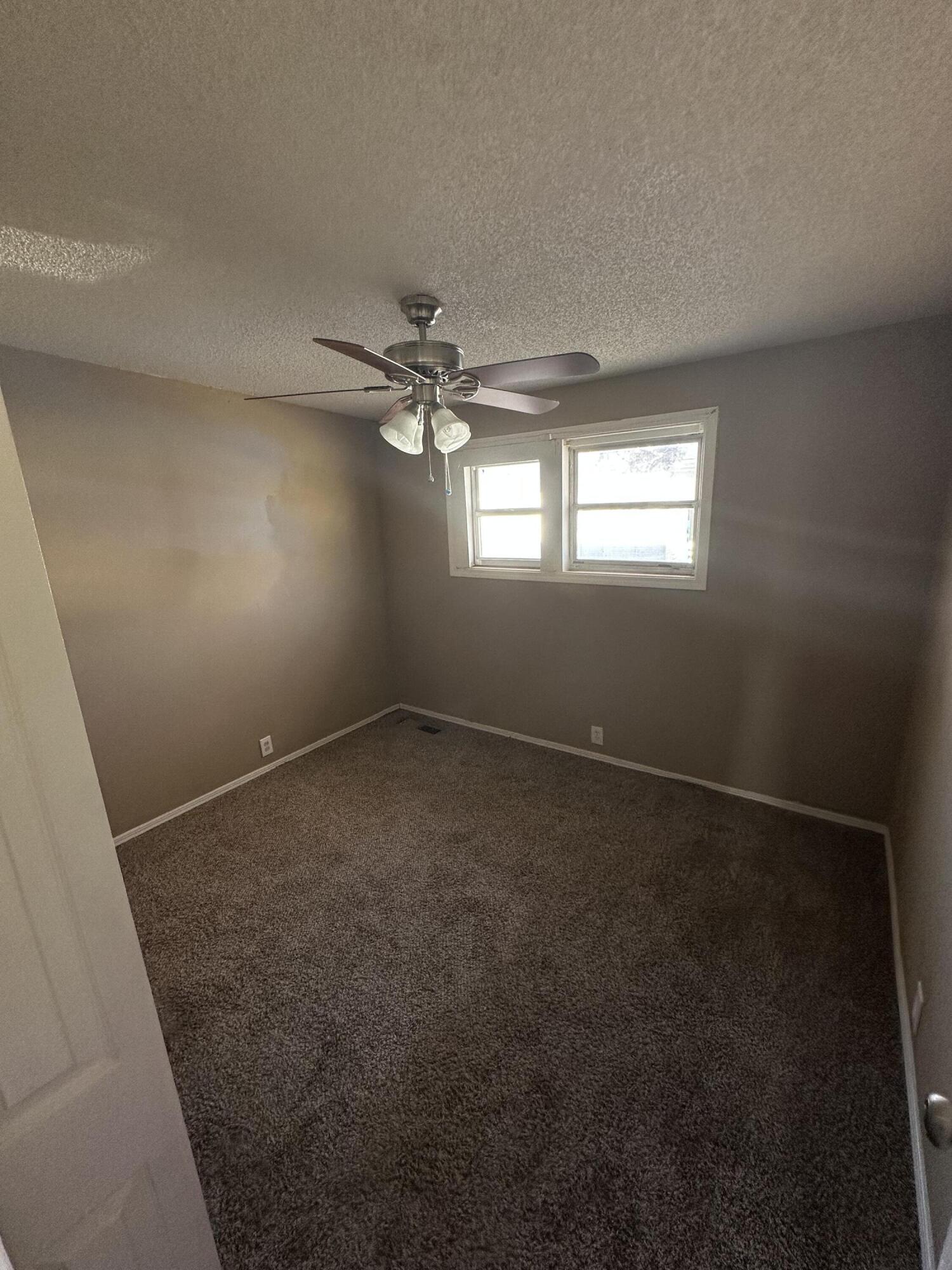 2416 47th Street Lubbock, TX 79412 - Photo 8 of 23 an empty room with a empty space and windows
