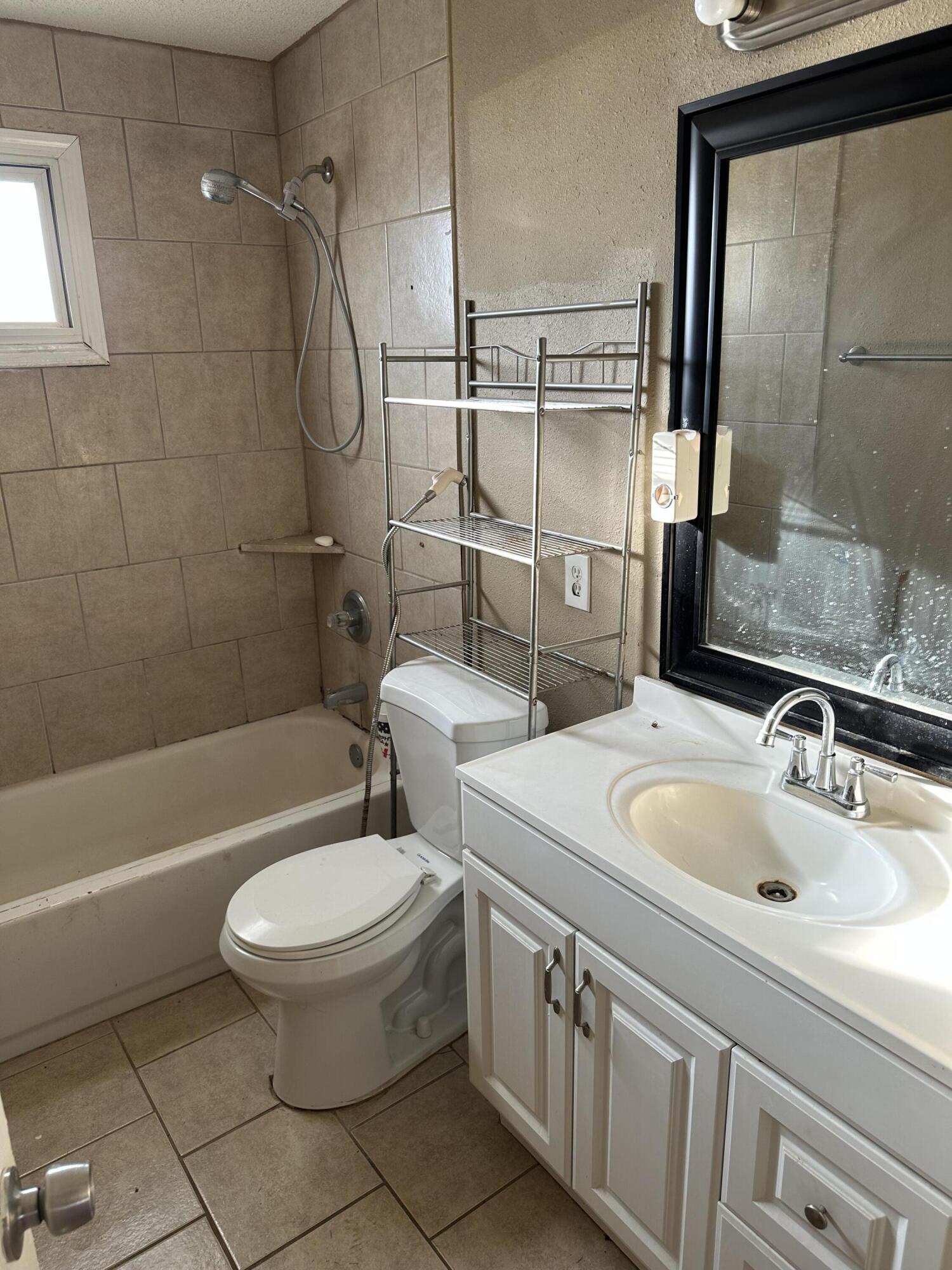 2416 47th Street Lubbock, TX 79412 - Photo 9 of 23 a bathroom with a sink toilet and shower