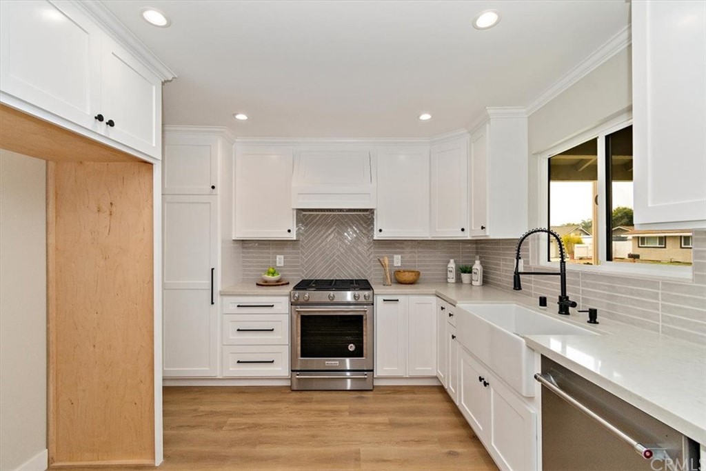 14101 Cameron Lane North Tustin, CA 92705 - Photo 13 of 36 a kitchen with a sink stove and cabinets