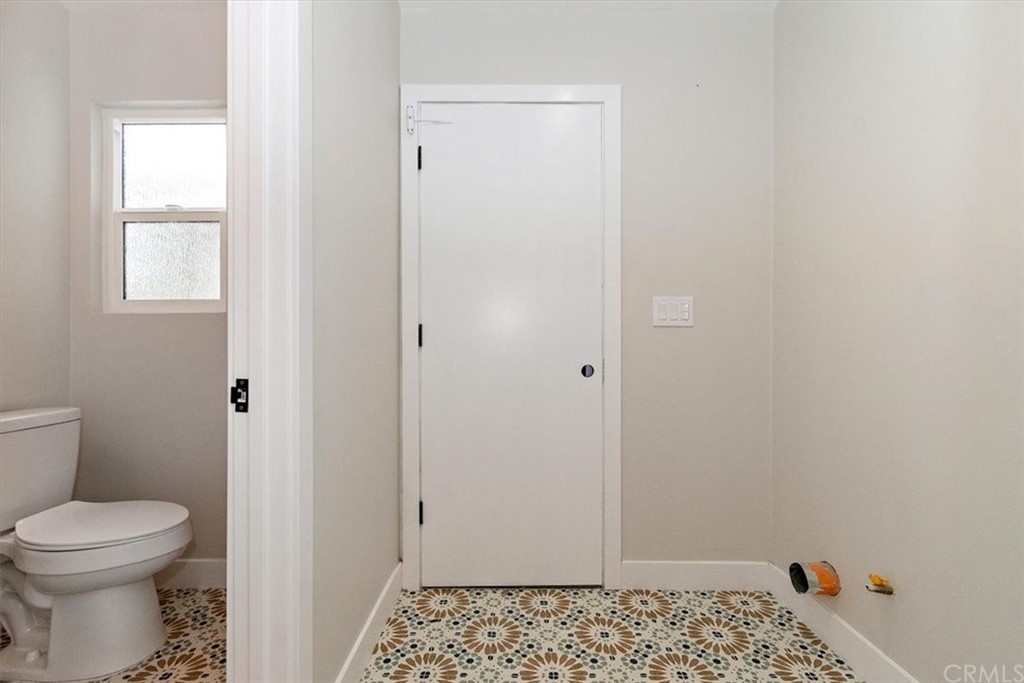 14101 Cameron Lane North Tustin, CA 92705 - Photo 16 of 36 a bathroom with a toilet sink vanity and mirror