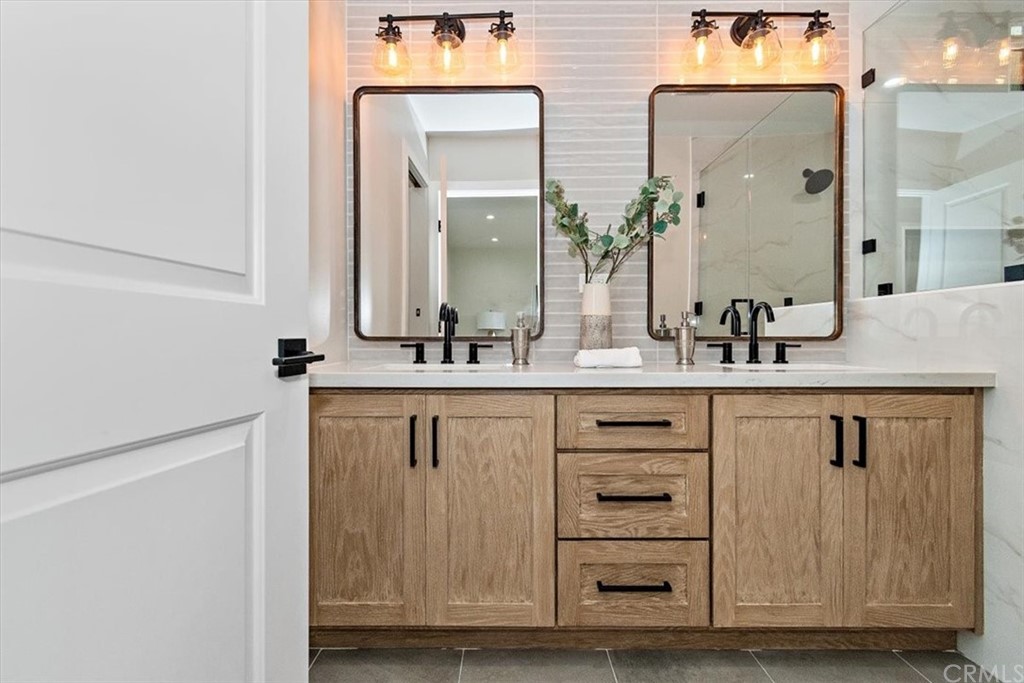 14101 Cameron Lane North Tustin, CA 92705 - Photo 21 of 36 a bathroom with a double sink shower and a mirror