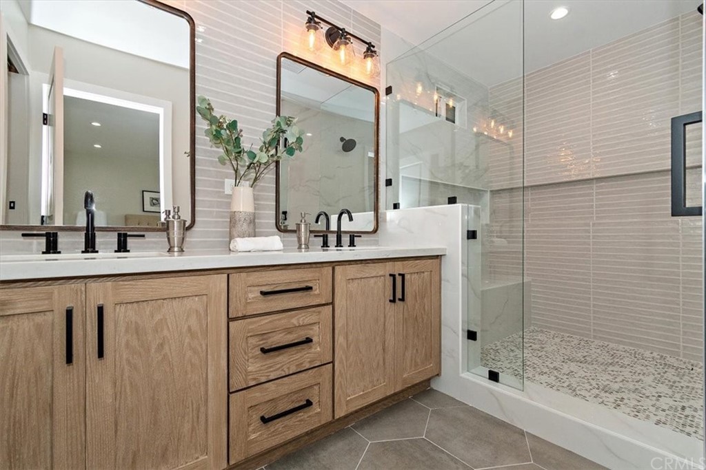 14101 Cameron Lane North Tustin, CA 92705 - Photo 22 of 36 a bathroom with a double vanity sink mirror and shower