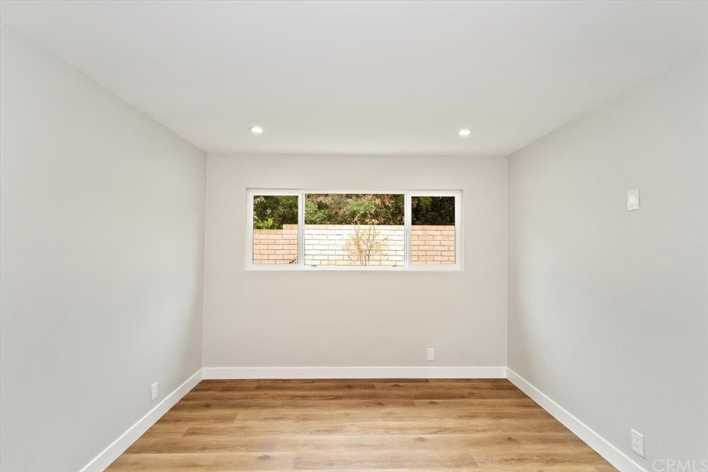 14101 Cameron Lane North Tustin, CA 92705 - Photo 29 of 36 an empty room with wooden floor and white doors