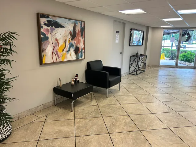 a living room with furniture and flowers