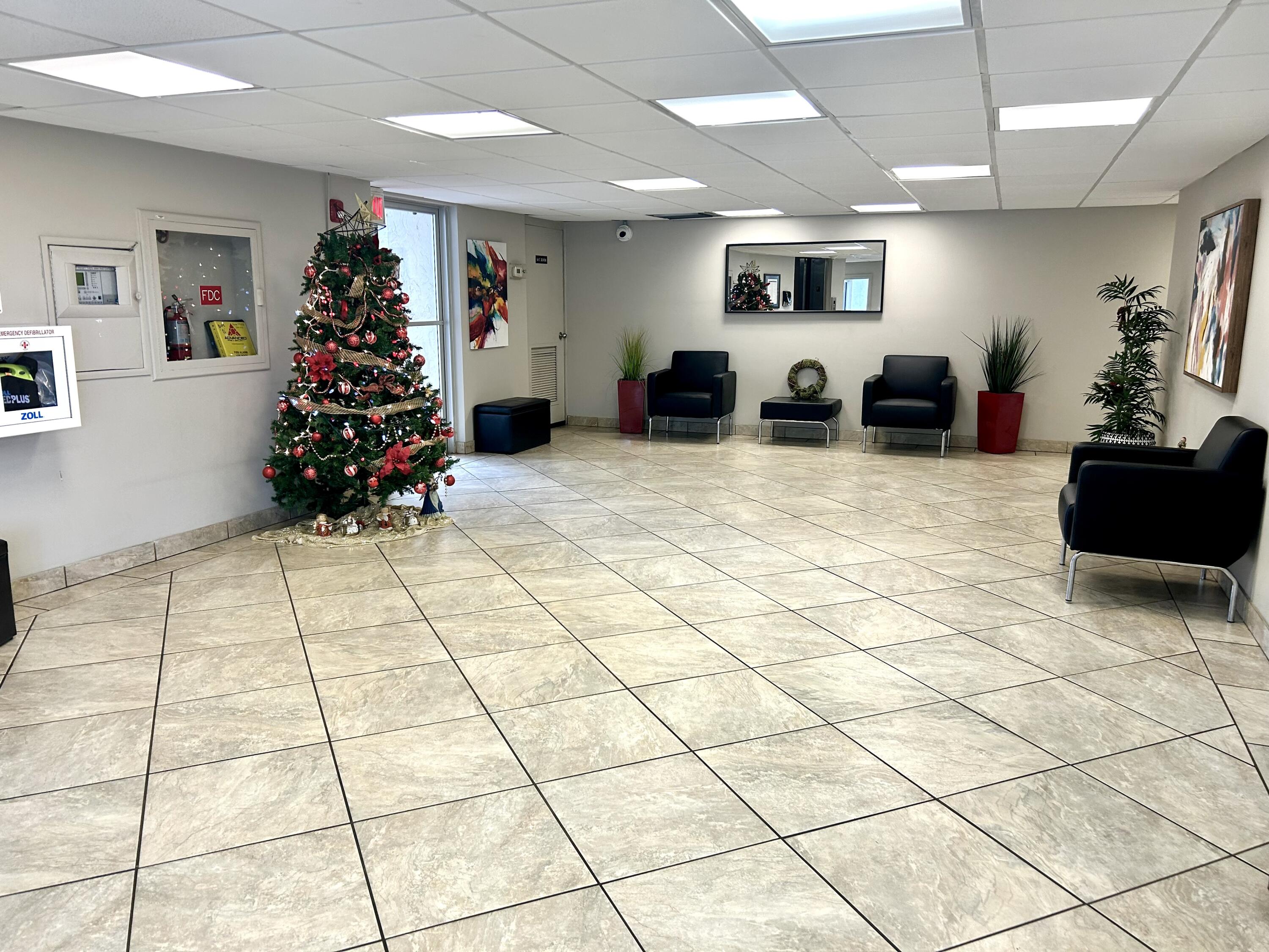 3930 Inverrary Boulevard, Unit 303D Lauderhill, FL 33319 - Photo 24 of 28 a living room with furniture and flowers