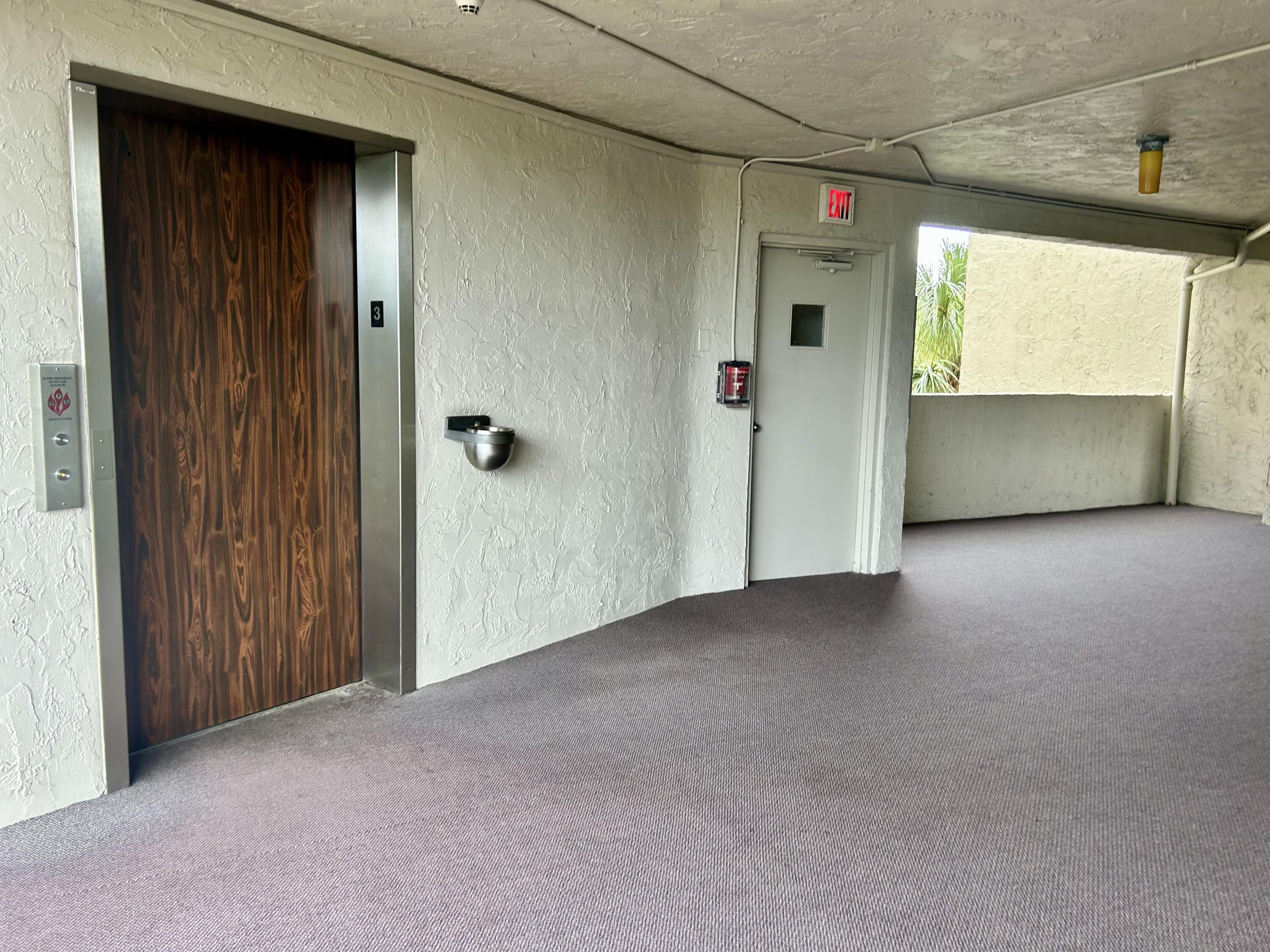 3930 Inverrary Boulevard, Unit 303D Lauderhill, FL 33319 - Photo 25 of 28 a view of a hallway with wooden shelves