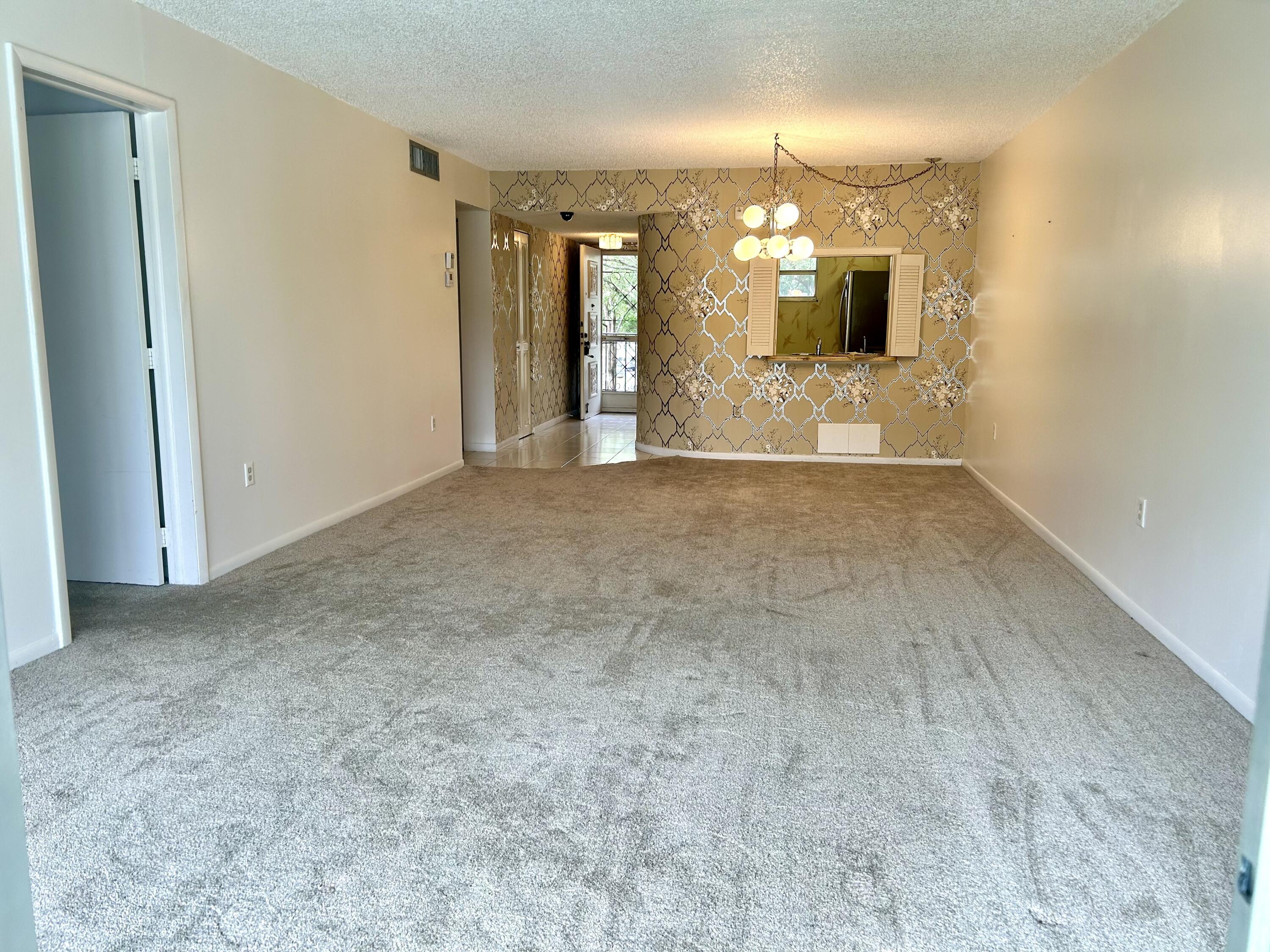 3930 Inverrary Boulevard, Unit 303D Lauderhill, FL 33319 - Photo 4 of 28 a view of a bathroom with a sink and a mirror
