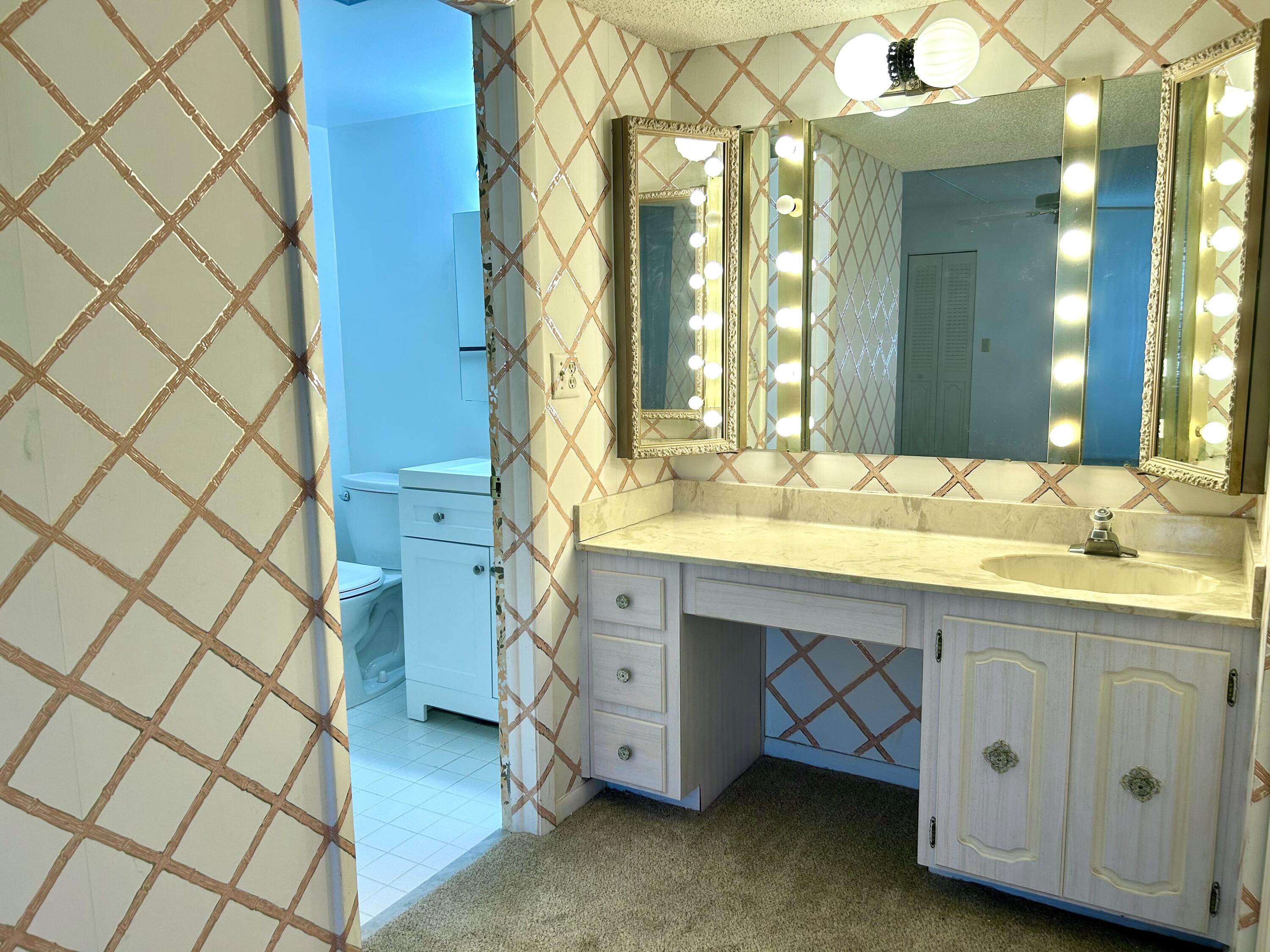 3930 Inverrary Boulevard, Unit 303D Lauderhill, FL 33319 - Photo 9 of 28 a bathroom with a sink and a mirror