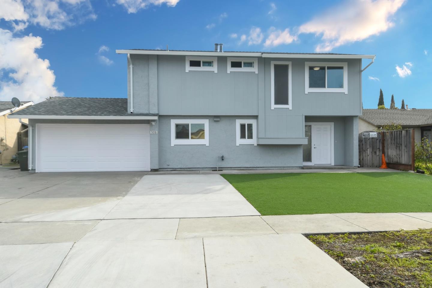 a front view of a house with a yard and a garage