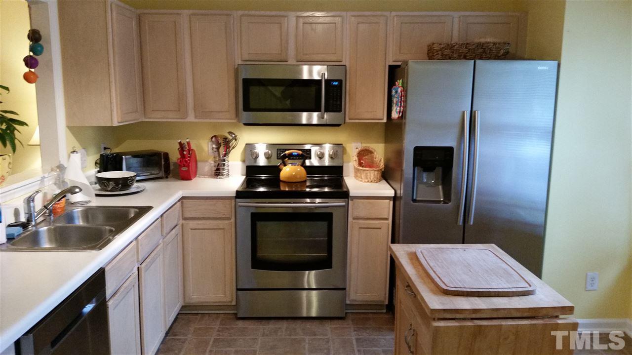 3802 Axle Lane Raleigh, NC 27616 - Photo 3 of 14 a kitchen with a sink appliances and cabinets