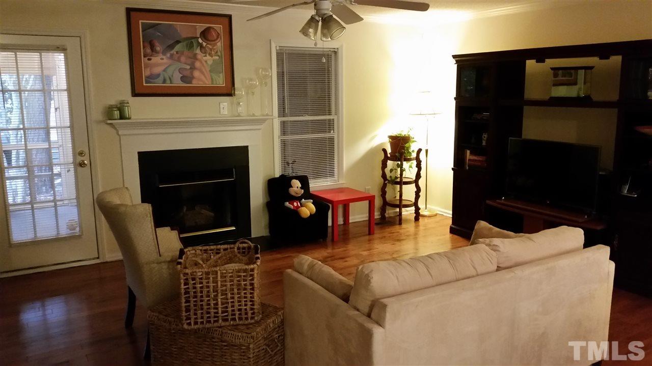 3802 Axle Lane Raleigh, NC 27616 - Photo 5 of 14 a living room with furniture a flat screen tv and a fireplace