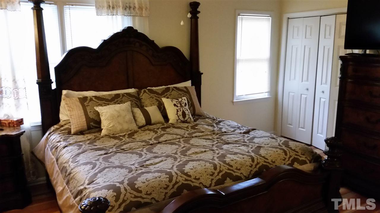 3802 Axle Lane Raleigh, NC 27616 - Photo 7 of 14 a bed sitting in a bedroom next to a window