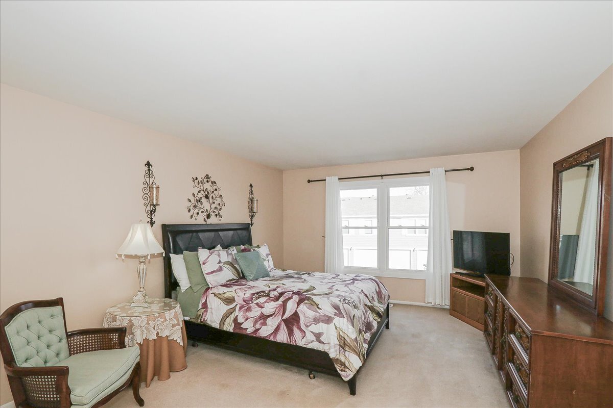 247 Nantucket Harbor Schaumburg, IL 60193 - Photo 13 of 25 a bedroom with a bed and a flat screen tv