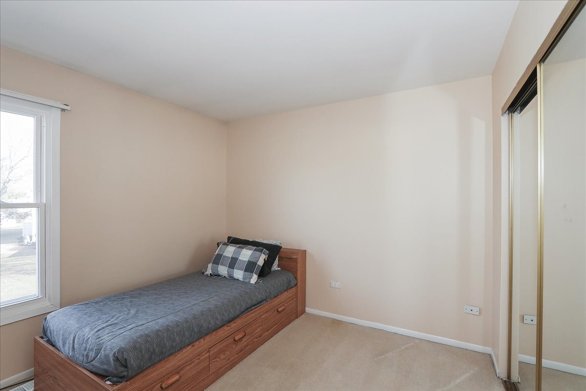 247 Nantucket Harbor Schaumburg, IL 60193 - Photo 15 of 25 a bed sitting in a bedroom next to a window