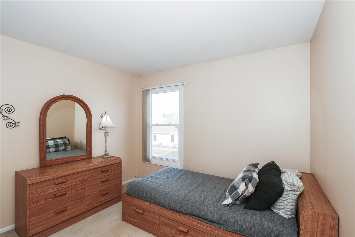 247 Nantucket Harbor Schaumburg, IL 60193 - Photo 16 of 25 a bed room with a bed and a dresser