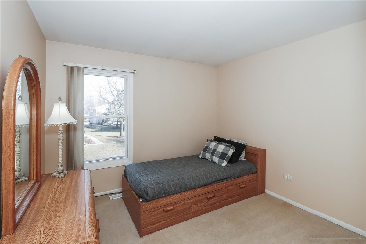 247 Nantucket Harbor Schaumburg, IL 60193 - Photo 17 of 25 a bedroom with a bed and window