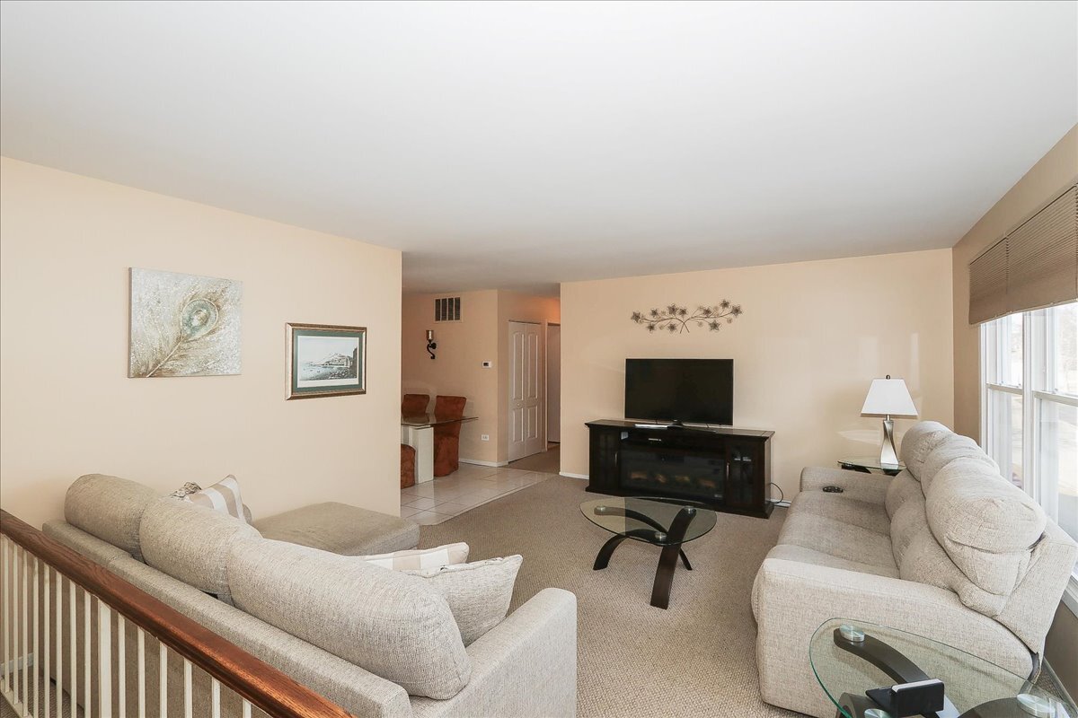 247 Nantucket Harbor Schaumburg, IL 60193 - Photo 4 of 25 a living room with furniture and a flat screen tv