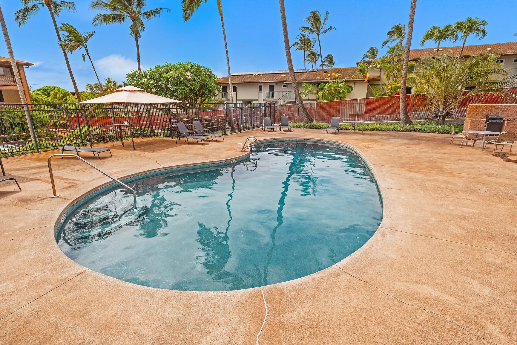 3740 Lower Honoapiilani Road, Unit G108 Lahaina, HI 96761 - Photo 22 of 24 a view of a swimming pool with a lounge chairs