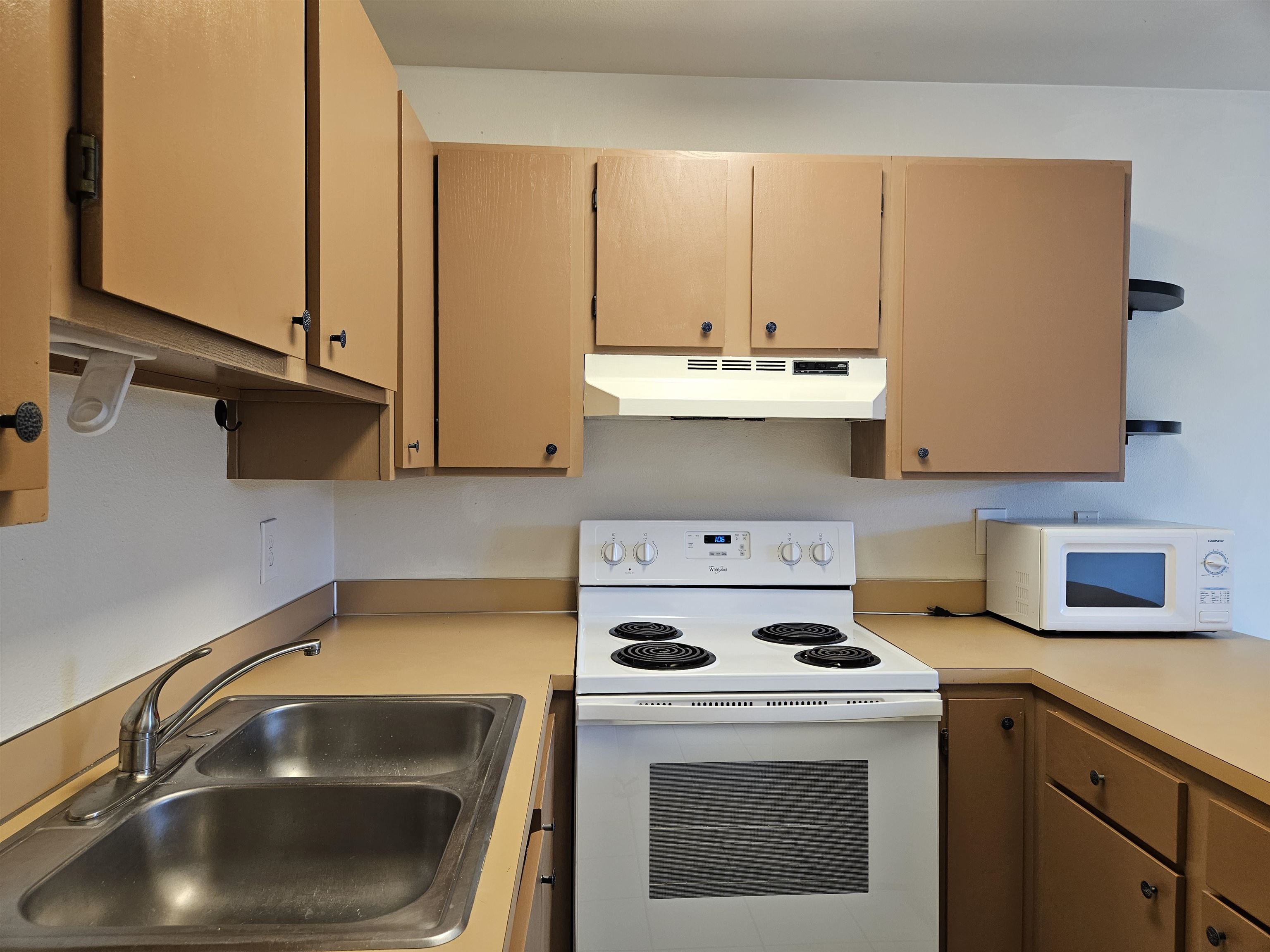 3740 Lower Honoapiilani Road, Unit G108 Lahaina, HI 96761 - Photo 10 of 24 a kitchen with a sink a stove and cabinets