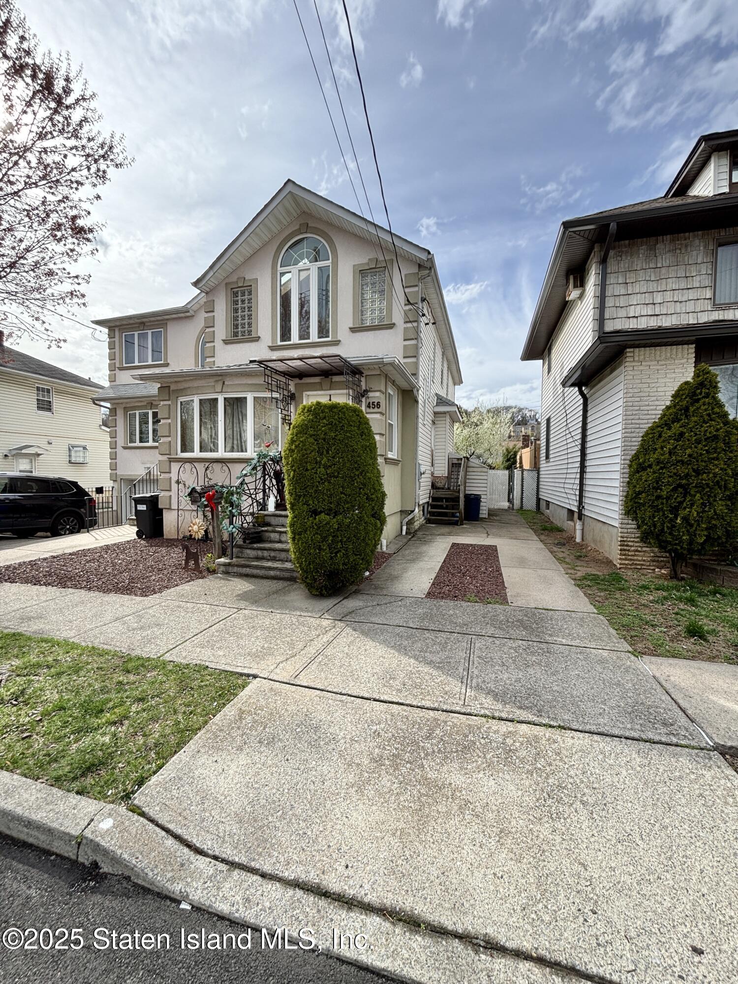 456 Oder Avenue Staten Island, NY 10304 - Photo 1 of 8 a front view of a house with a garden and plants