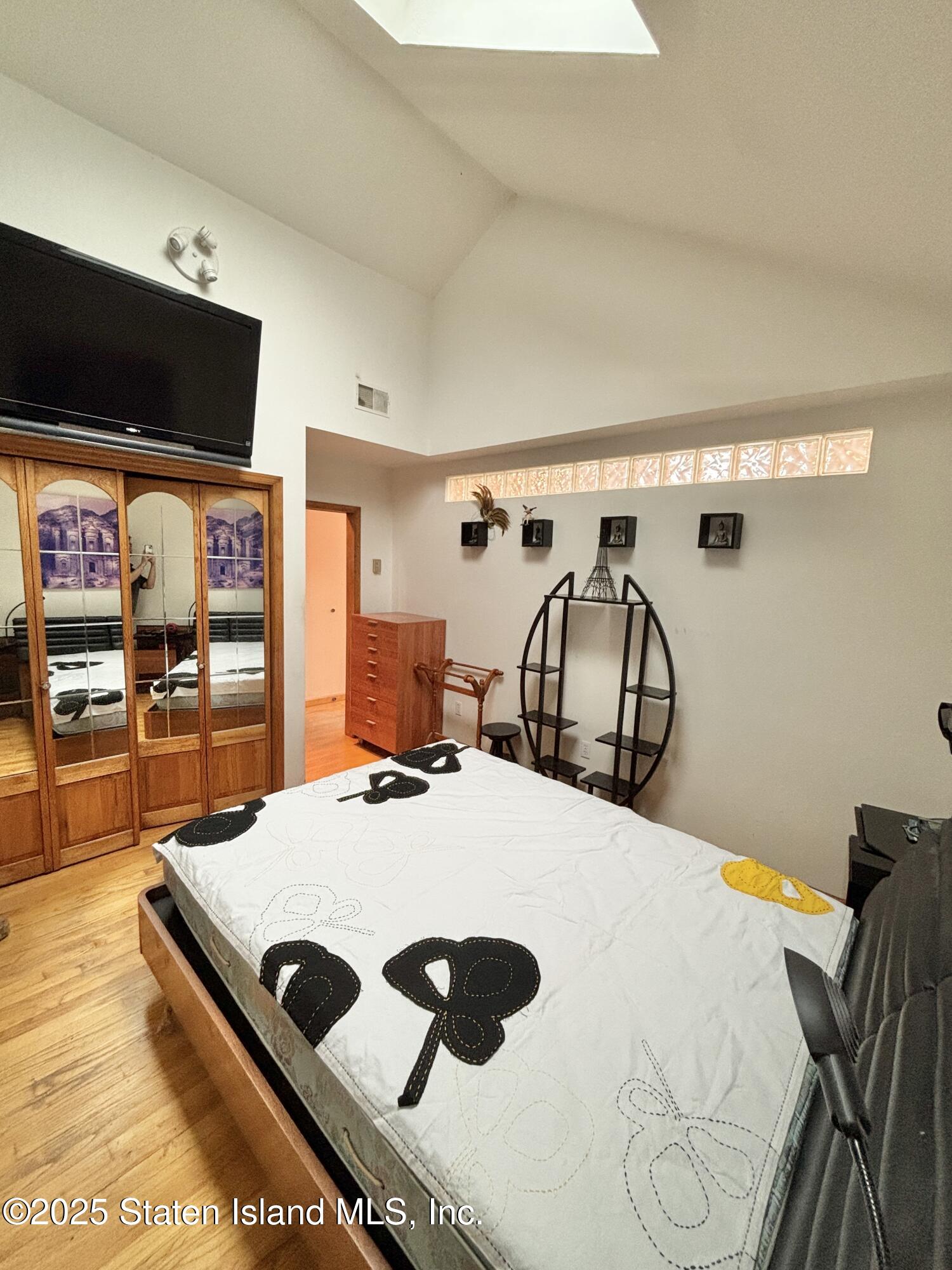 456 Oder Avenue Staten Island, NY 10304 - Photo 4 of 8 a room with a bed a flat screen tv and a table