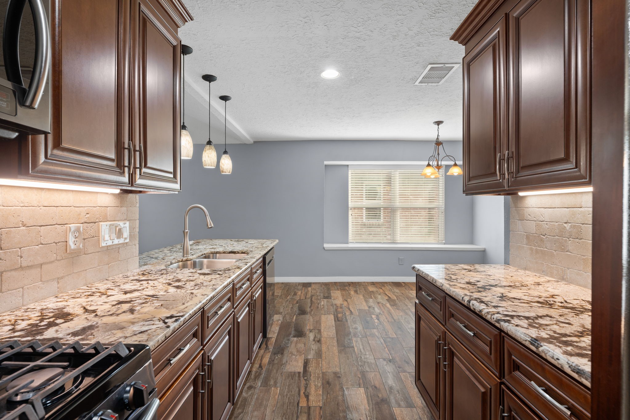 2622 Strait Lane Houston, TX 77084 - Photo 11 of 47 a kitchen with a stove and a wooden floor