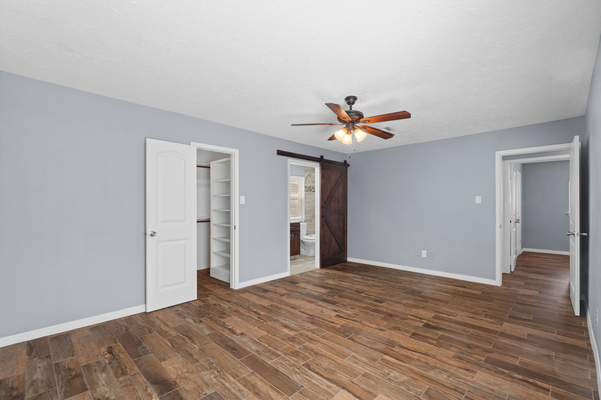 2622 Strait Lane Houston, TX 77084 - Photo 19 of 47 a view of a livingroom with a chandelier fan and wooden floor
